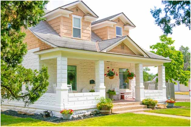 A house with a porch and a lawn